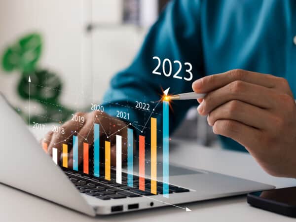 Businessman analyzes profitability of working companies with digital augmented reality graphics, positive indicators in 2023, businessman calculates financial data for long-term investments.